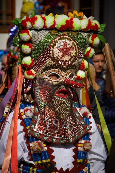 SHIROKA LAKA, BULGARIA - MARCH 5: People dressed in traditional costumes called Kukeri celebrate arrival of Spring with ritual dances in Shiroka Laka, Bulgaria, on March 5, 2017. Stock Photo
