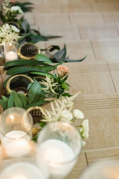Close up of floral wedding decorations and candles on stairs