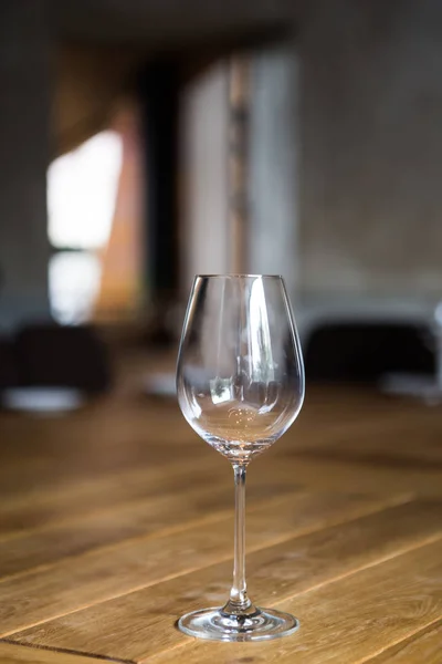 Una copa de vino vacía está sobre una mesa de madera — Foto de Stock