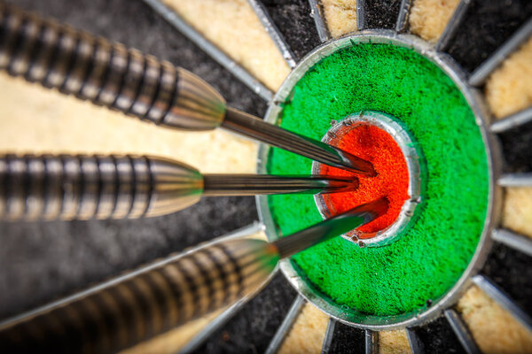 three darts in bull's eye, close up