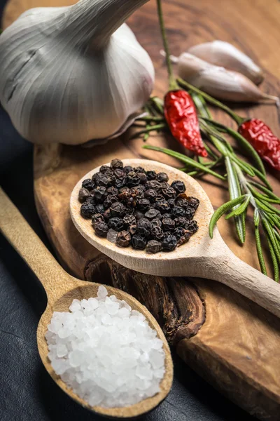 Chili with black pepper and salt on rustic wooden table. — Stock Photo, Image