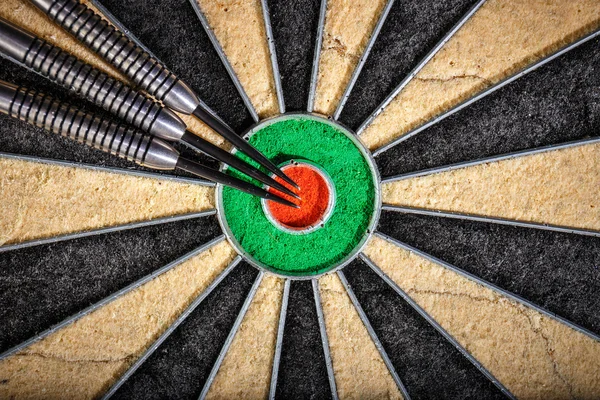 Three darts lying on dartboard, close up — Stock Photo, Image