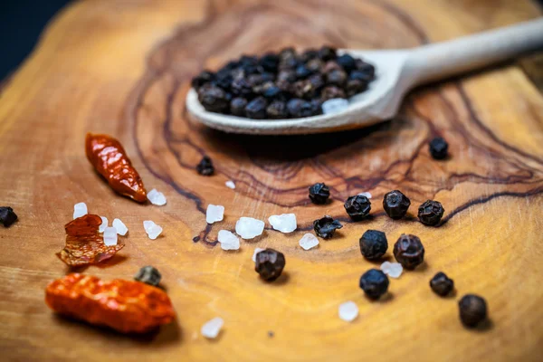 Chili with black pepper and salt on rustic wooden table. Overhead view food photography. — Stock Photo, Image