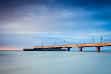 Beton iskelesi Kolobrzeg, gün batımında atış uzun pozlama