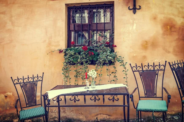 Table and chairs at a cafe, vintage look — Stock Photo, Image