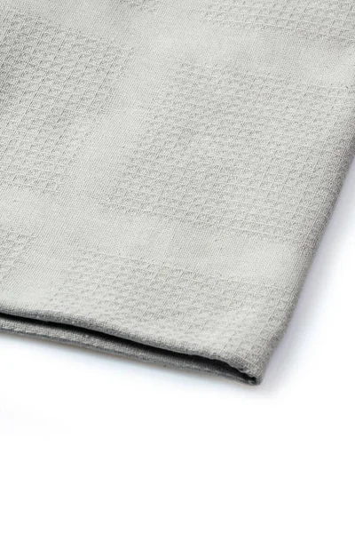 Διπλωμένη πετσέτα γκρι λευκό φόντο, κοντινό πλάνο — Φωτογραφία Αρχείου