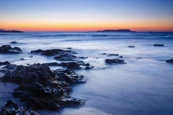 Günbatımı deniz ve kumsal, uzun pozlama yıkama dalga üzerinde — Stok fotoğraf