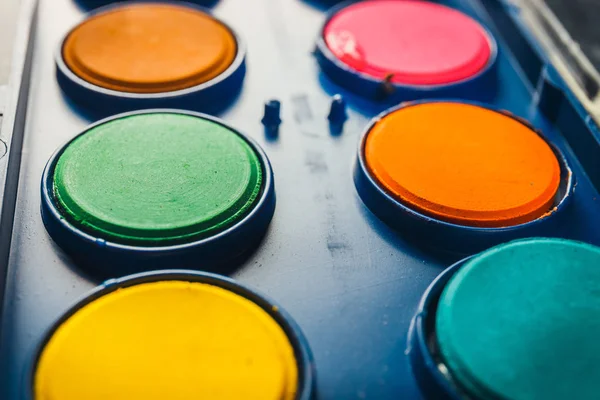 Watercolor paints in a box with paintbrush, close up — Stock Photo, Image