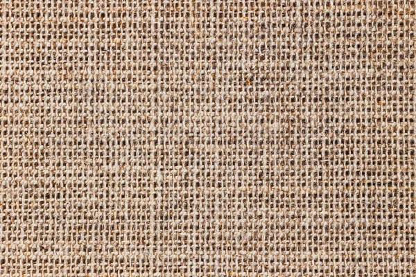 Textured background of a sandy brown burlap cloth, close up — Stock Photo, Image