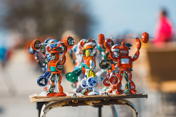 Kolobrzeg, Poland, April 08, 2016: Strongman figurines made from bottle caps and sold on the promenade next to the beach by a local artist — Stock Photo, Image