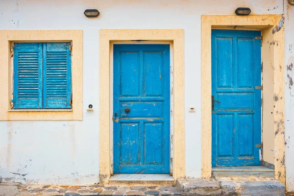 Blue shutters and doors on a white wall, close up — Stock Photo, Image