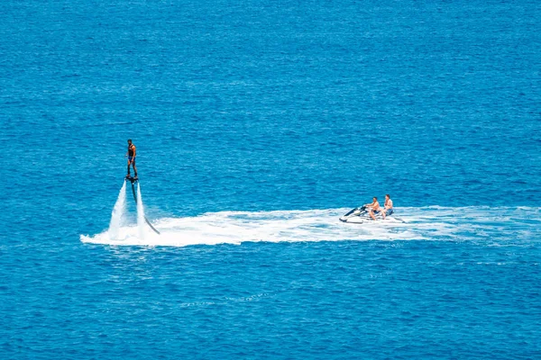 Crete, Greece - June 11, 2017: Flyboard show on the Vai Beach on the Island of Crete, Greece. Flyboard is the new spectacular extreme sport — Stock Photo, Image