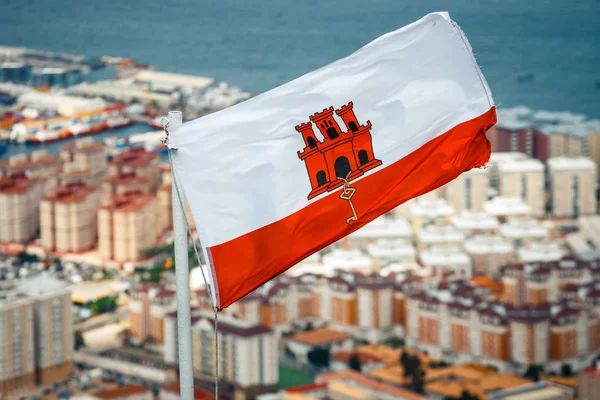 Close up of Gibraltar flag waving against blue sky — Stock Photo, Image