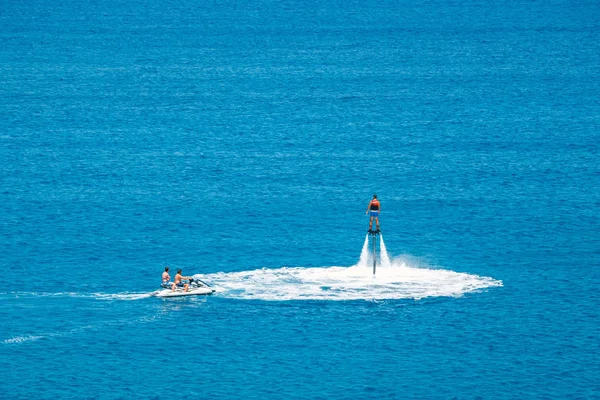 Crete, Greece - June 11, 2017: Flyboard show on the Vai Beach on the Island of Crete, Greece. Flyboard is the new spectacular extreme sport — Stock Photo, Image