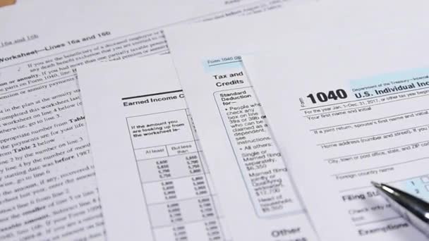 Tax form 1040 and pen on the desk. dolly shot — Stock Video