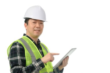 Middle-aged Asian engineer using tablet PC on a white background.