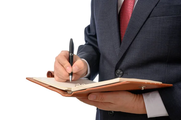 Biznesmen z notatnikiem w ręku i długopisem, żeby coś napisać. — Zdjęcie stockowe