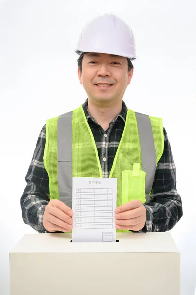 Мужская рука опустила бюллетень в урну для голосования . — стоковое фото