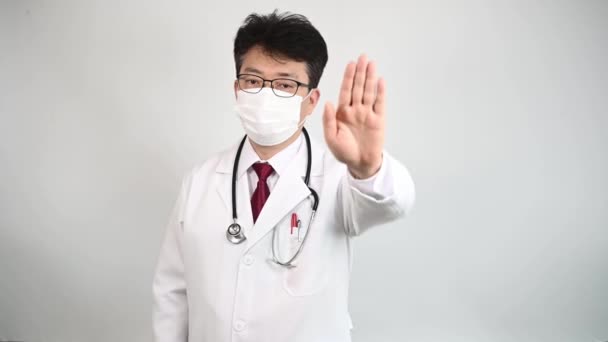 Middle Aged Asian Doctor Raises His Hand Expresses His Disapproval — Stock Video