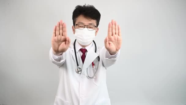 Middle Aged Asian Doctor Raises His Hand Expresses His Disapproval — Stock Video