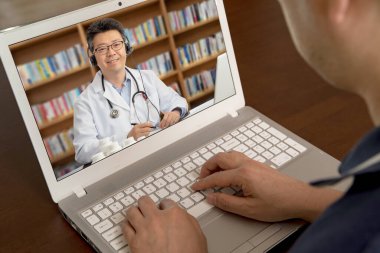 Hastanın birine uzaktan danışmanlık yapan Asyalı bir doktor. TeleHealth konsepti.