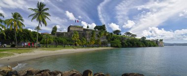 FORT-DE-FRANCE, MARTINIQUE - JANUARY 9, 2017 - The beach in center of Fort de France near walls of Fort Saint Louis. Fort de France is the capital of Martinique island, Lesser Antilles clipart
