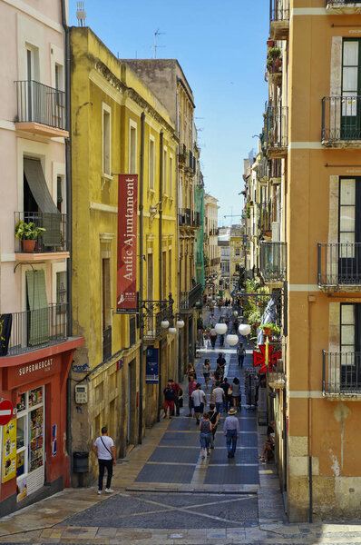 TARRAGONA, SPAIN - JUNE 30th, 2017: People is walking down the street leading to Tarragona Cathedral on June 30 - 2017, Catalonia, Spain