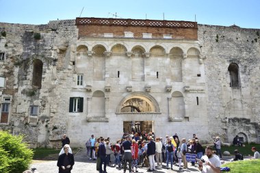 SPLIT, CROATIA - APRIL 29, 2019: People in the front of main gate to Diocletian's Palace in the old city of Split, Croatia