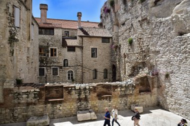 SPLIT, CROATIA - APRIL 29, 2019: Ancient buildings surrounding the Diocletian's Palace in Split city center at the sunny day in Croatia