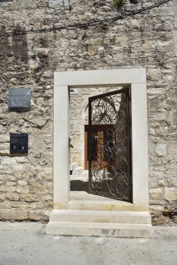 SPLIT, CROATIA - APRIL 29, 2019: Ancient buildings surrounding the Diocletian's Palace in Split city center at the sunny day in Croatia