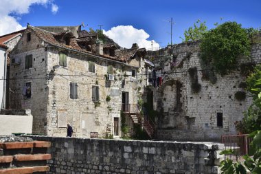 SPLIT, CROATIA - APRIL 29, 2019: Ancient buildings surrounding the Diocletian's Palace in Split city center at the sunny day in Croatia