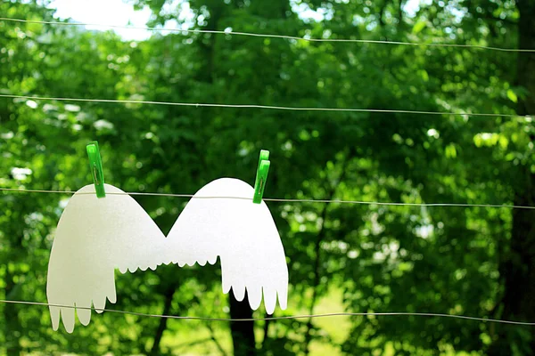 white angel wings on a clothesline