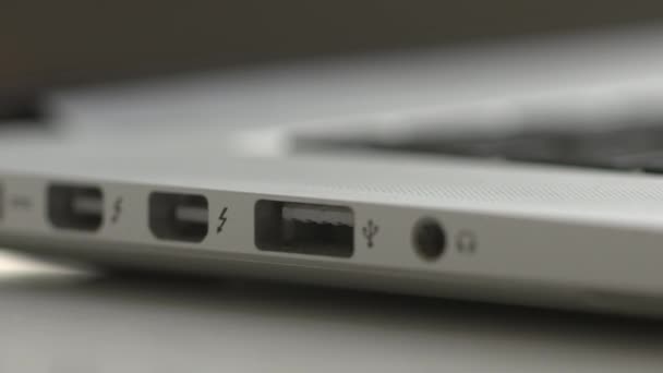 USB-stick wordt ingevoegd in de poort van een laptop — Stockvideo