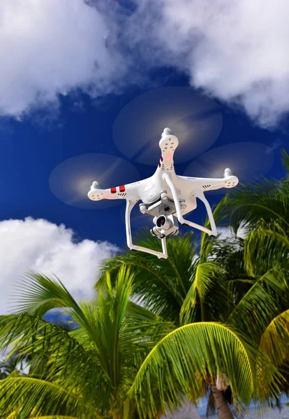 Drone copter flying with digital camera in tropics. Innovation photography concept.