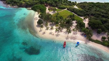 Aerial birds eye view photo taken by drone of tropical seascape and sandy beach with turquoise clear waters and palm trees. clipart