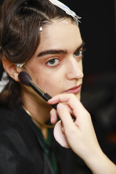 MILAN, ITALY - SEPTEMBER 23: A model getting ready  backstage before the Gabriele Colangelo show during Milan Fashion Week Spring/Summer 2018 on September 23, 2017 in Milan, Italy.