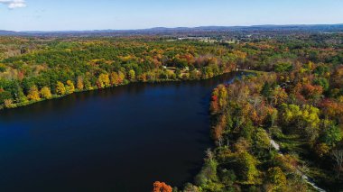 Aerial drone view of lake in autumn state park.  clipart