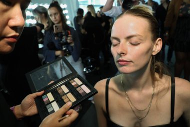 NEW YORK, NY - SEPTEMBER 08: A model getting ready backstage before the Custo Barcelona show during New York Fashion Week: The Shows at Pier 59 on September 8, 2018 in New York City. 