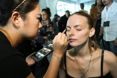 NEW YORK, NY - SEPTEMBER 08: A model getting ready backstage before the Custo Barcelona show during New York Fashion Week: The Shows at Pier 59 on September 8, 2018 in New York City. 