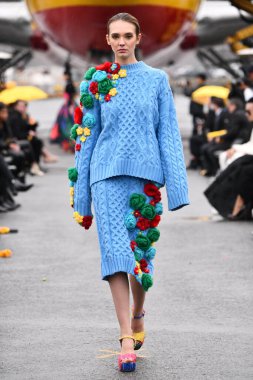 JAMAICA, NEW YORK - 06 Şubat 2020 'de DHL JFK Havalimanı' nda Jessica Minh Anhs Moda Fuarı sırasında VUNGOC ve Oğlu için podyumda bir model yürüyor 