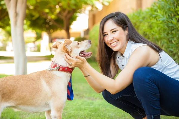 Woman petting her dog — Stock Photo, Image