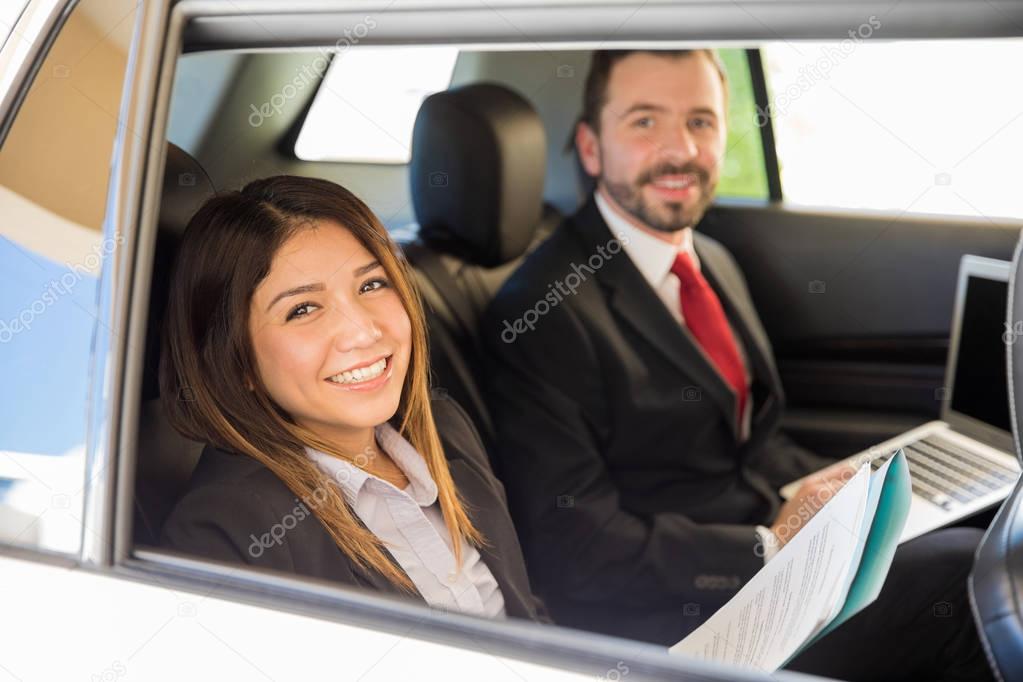  businesswoman and a coworker in  car