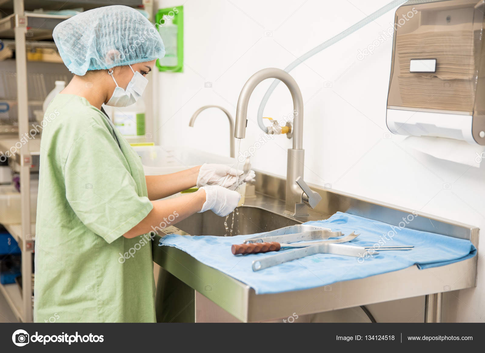Woman cleaning medical tools Stock Photo by ©tonodiaz 134124518
