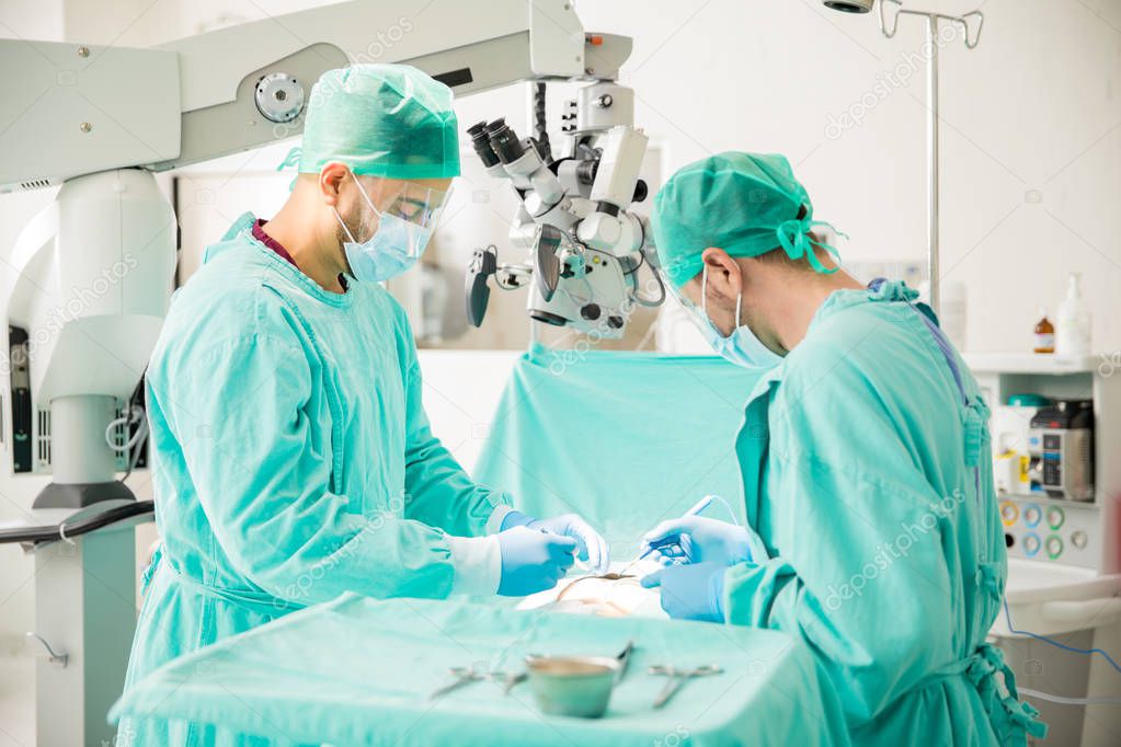 Surgeons working in operating room