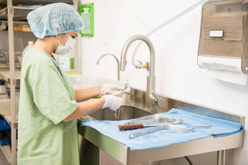 Woman cleaning medical tools