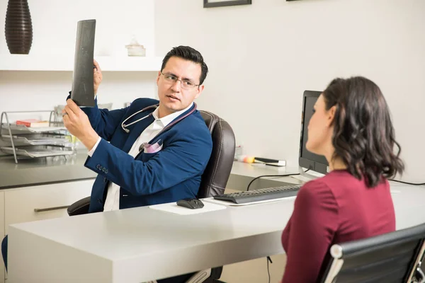 Doctor explaining x-rays to patient — Stock Photo, Image