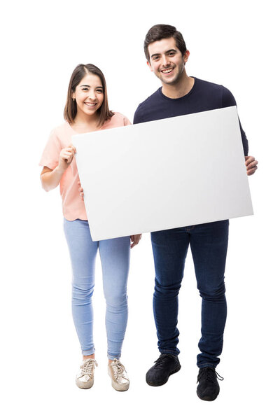 Hispanic couple holding sign