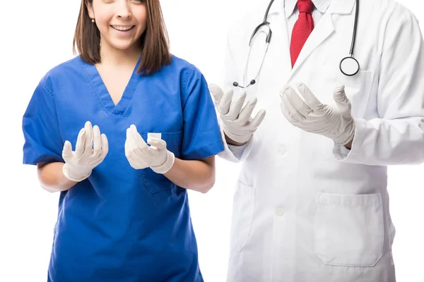 Doctor and nurse wearing gloves — Stock Photo, Image