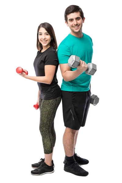 Couple lifting dumbells — Stock Photo, Image