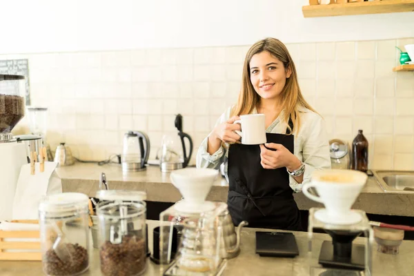 Barista holding cup of coffee — Stock Photo, Image